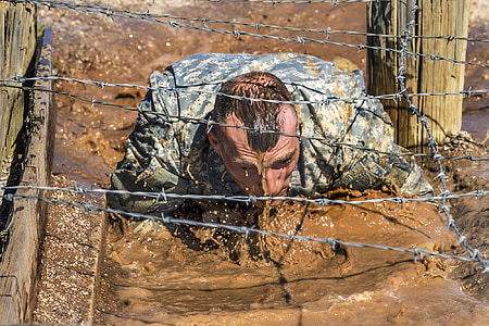 man crawling on mud under the barbwire thumbnail