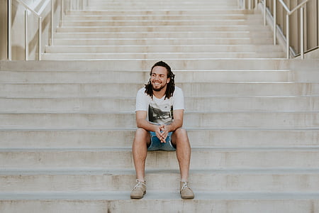 smiling man sitting on stair thumbnail