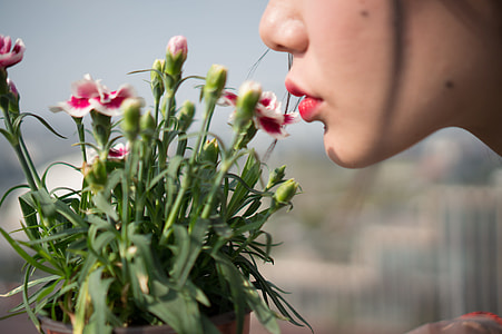 woman about to kiss the petaled flower thumbnail