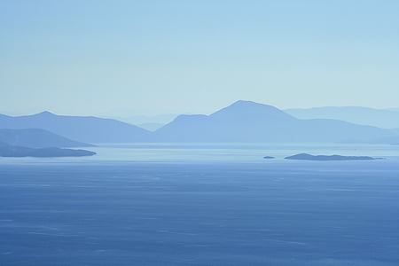 calm body of water near mountain thumbnail