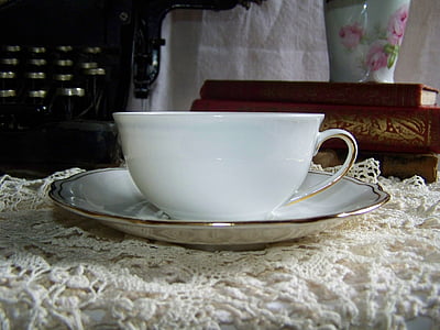 white ceramic teacup on white plate thumbnail
