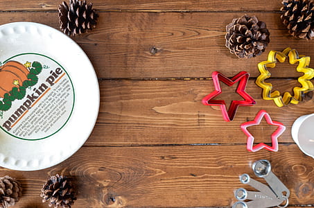flat lay photography of cookie cutter, measuring spoon, and pine cone lot thumbnail