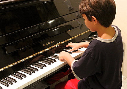 boy wearing black shirt playing Kawai piano thumbnail