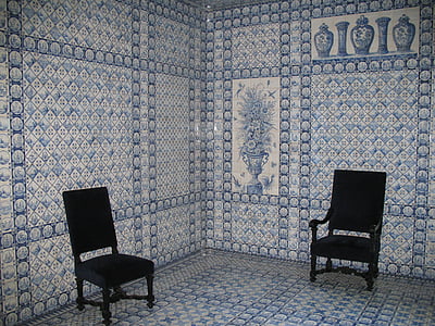 two black chairs on floral floor thumbnail