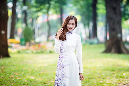woman wearing white and purple long-sleeved dress during day time thumbnail