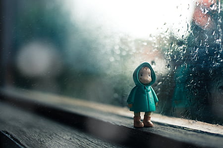 figurine beside glass window thumbnail