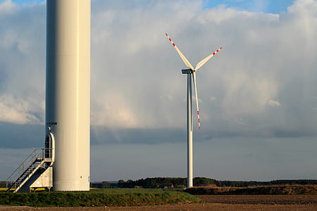 white windmill under white sky thumbnail