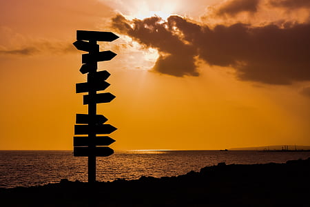 silhouette photography of wooden road signage thumbnail