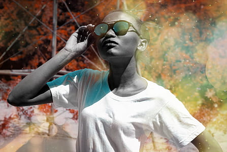 woman standing while holding sunglasses thumbnail