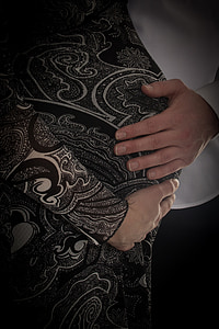 close-up photo of person holding tummy of pregnant woman thumbnail