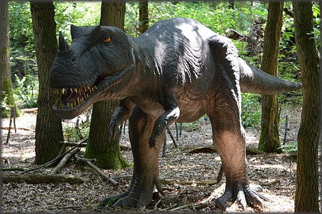 dinosaur statue in forest thumbnail