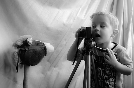 grayscale photo of boy using camera thumbnail