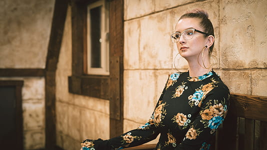 woman sitting on brown wooden bench thumbnail