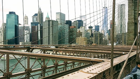 gray suspension bridge near buildings thumbnail