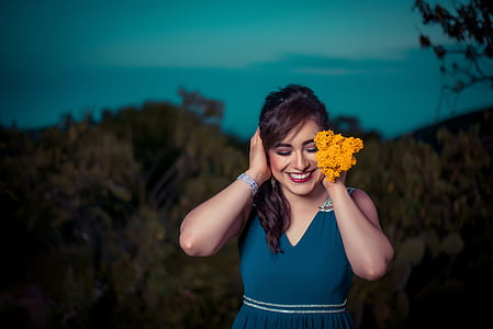 woman wearing blue dress covering its ears thumbnail