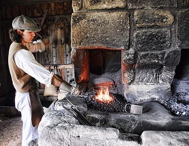 blacksmith putting metal on fire thumbnail