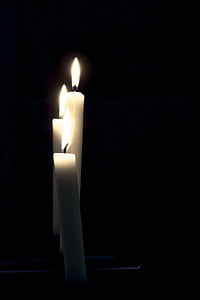 three lighted white taper candles thumbnail