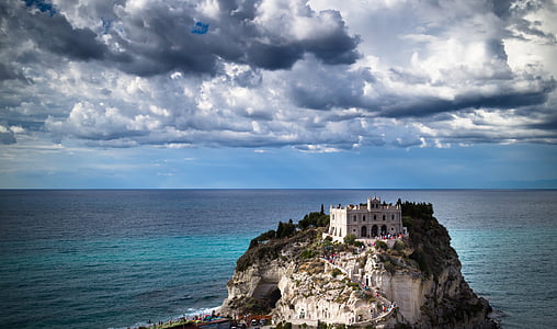 gray castle in the middle of body of water thumbnail