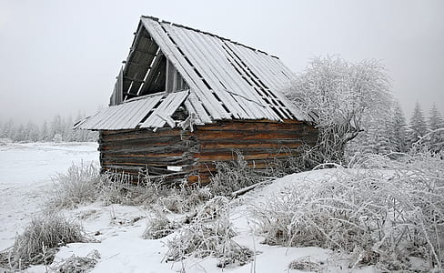 brown wooden house covered with snow thumbnail