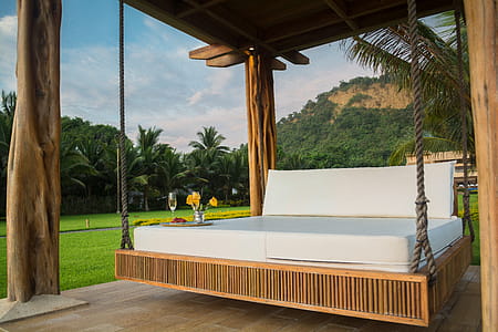 Brown Wooden Framed With White Mattress Hanging Bed Surrounded by Green Grass thumbnail