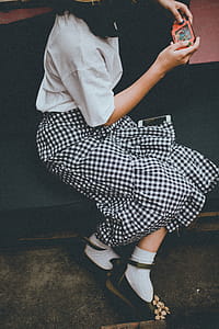 Closeup Photo of Girl Playing Portable Console While Sitting in the Sofa thumbnail