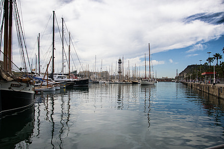 assorted-color boats on dock at daytime thumbnail