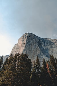 gray mountain near tree under white cloud thumbnail