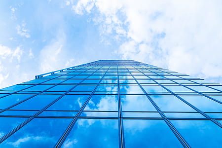 Sky with clouds in the reflection in windows of modern office building thumbnail