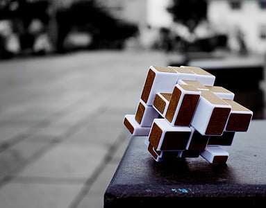 white and brown Rubik's Cube on black surface thumbnail