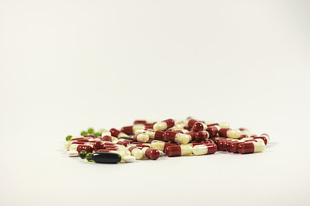 red and white medicine capsules thumbnail