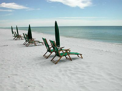 six brown-and-green folding loungers on beach thumbnail