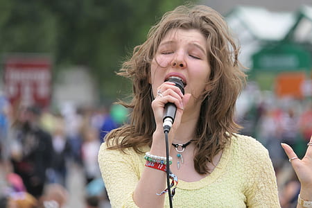 selective focus photograph of singing woman thumbnail