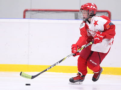 selective focus photography of ice hockey player on ice field thumbnail