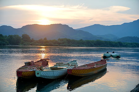 three canoes on body of water thumbnail
