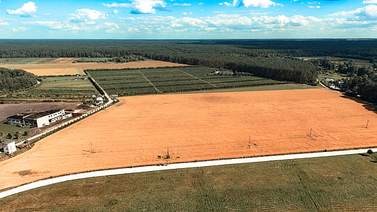 aerial photo of brown and green grass field at daytime thumbnail