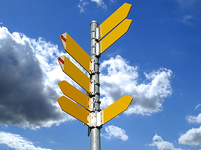 yellow left and right arrows signage under white clouds at daytime thumbnail