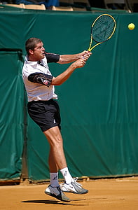 man playing tennis during daytime thumbnail