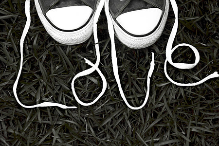 flat lay photography of pair of love unlaced shoes thumbnail