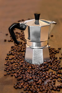 closeup photo moka pot and coffee beans on brown wooden surface thumbnail