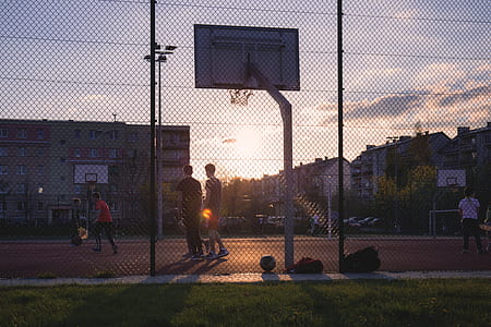 men playing basketball during golden hour thumbnail