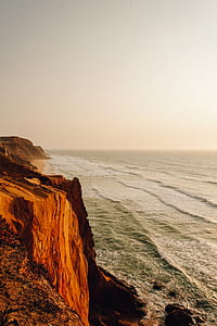 cliff near body of water thumbnail