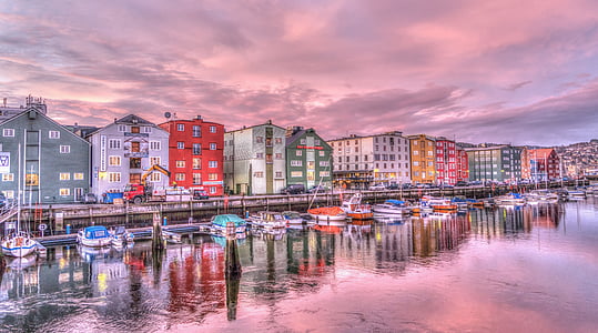 assorted-color house near sea photo thumbnail