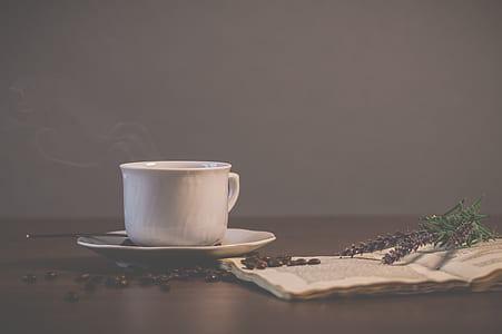 white ceramic cup of coffee on brown surface thumbnail