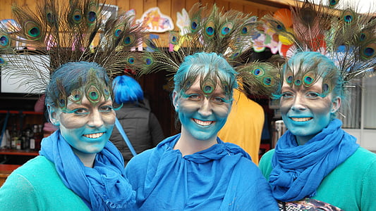 three woman wearing peacock feather headdress thumbnail