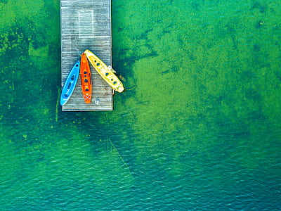 aerial view of blue, red, and yellow kayak boats thumbnail