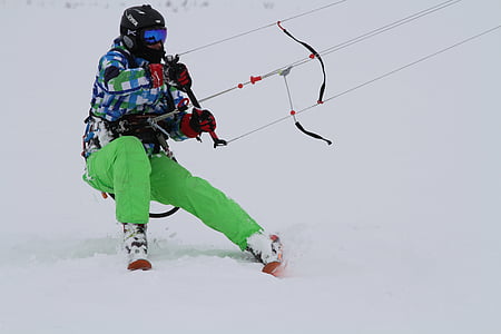 person skiing on snow while holding on harness thumbnail
