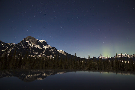 mountain surrounded by tree near body of water thumbnail