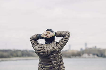 Person Holding Head Facing Body of Water thumbnail