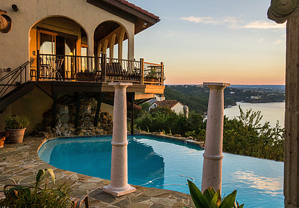 two white metal balusters near below-ground pool during daytime thumbnail