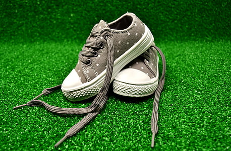 pair of toddler's gray low-top sneakers on green grass thumbnail